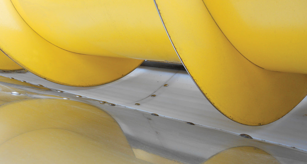 White auger liner installed in New Holland grain head
