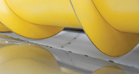 White auger liner installed in New Holland grain head