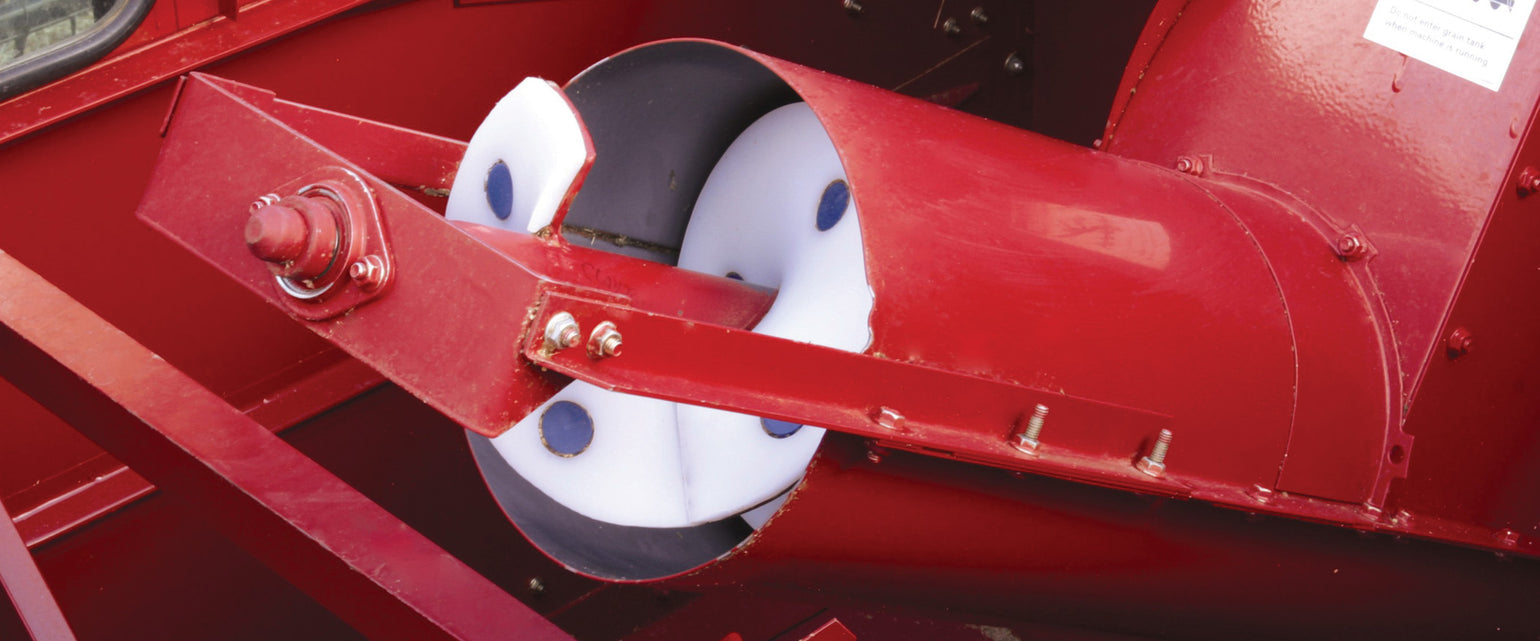 Person installing poly auger wearshoe on auger