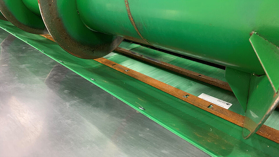 Green poly auger trough liner installed in Larson Farms grain head