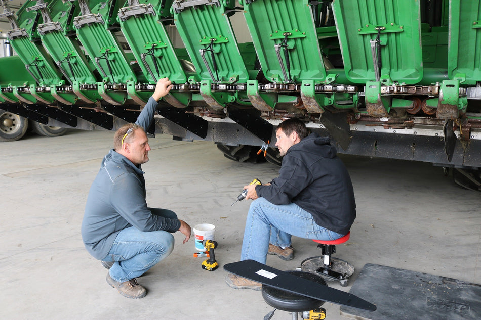 Eric from May Wes and Zach Johnson Millennial Farmer installing May Wes Row Divider Shields on John Deere chopping corn head