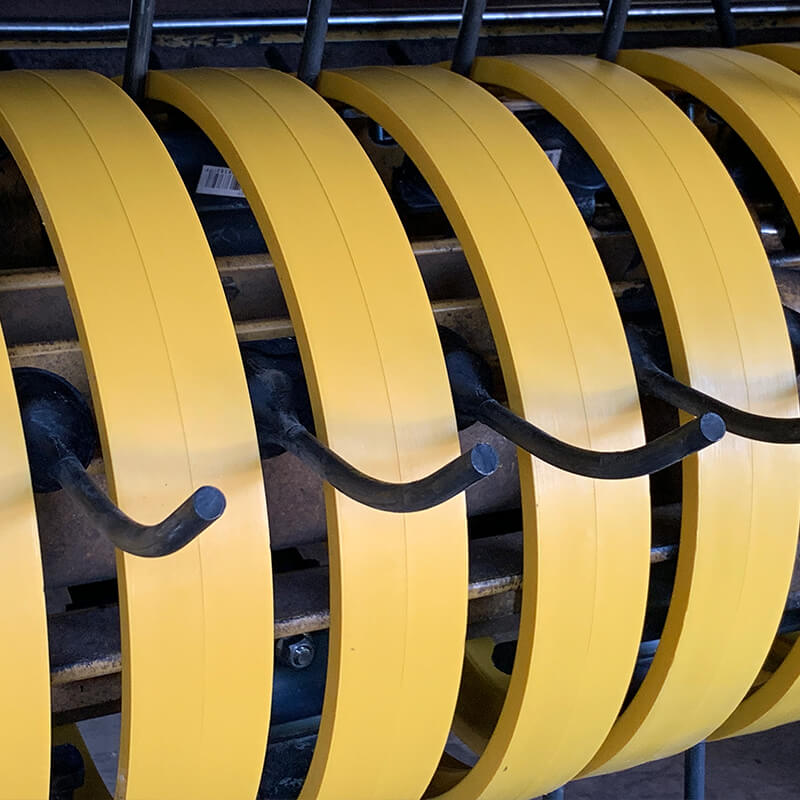 Yellow poly pickup bands and Black Talon rubber pickup teeth on Vermeer baler