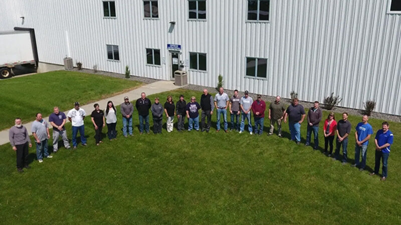 Aerial photo of Pride Solutions employees in front of manufacturing facility