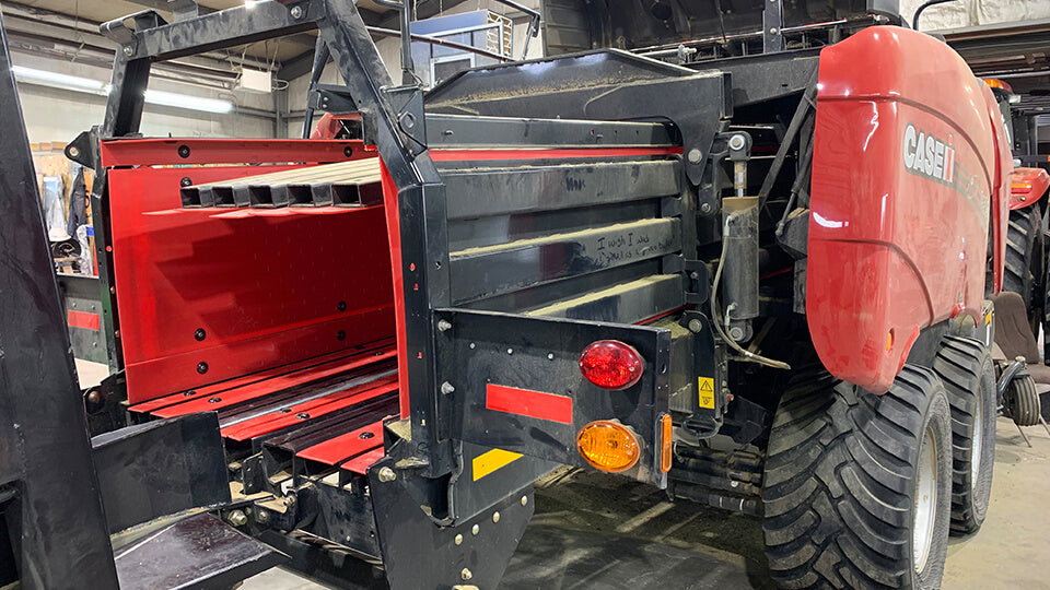 Red BaleSkiis baler liner installed in a Case IH LB434 square baler