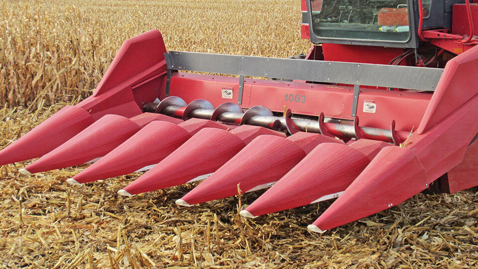 Red GVL Poly corn snouts installed on Case IH 1063 corn head in the field