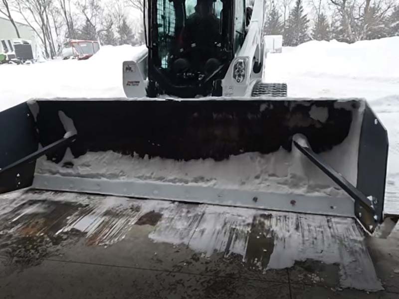 plowing snow with Bobcat skid loader