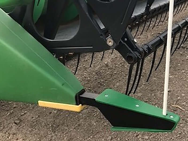 Green crop divider installed on John Deere grain head