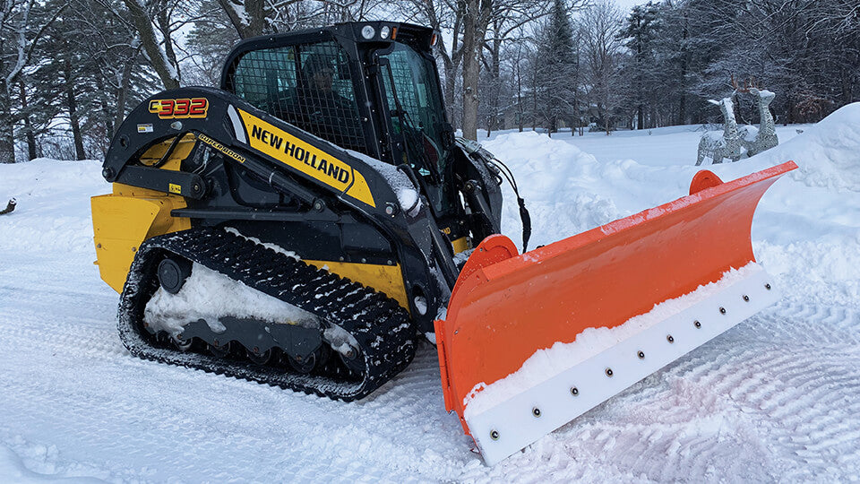 May Wes poly cutting edge installed on an orange Skid Pro Snow Plow with New Holland skid loader
