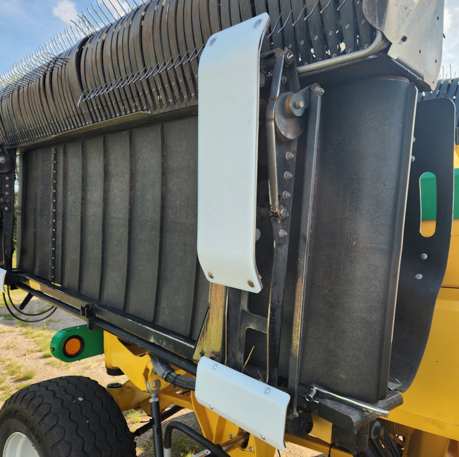 White UHMW poly skid shoes installed on Oxbo hay merger