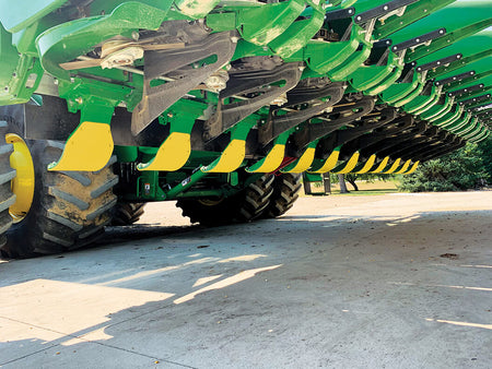 Yellow poly covers on John Deere C-Series OEM stalk stompers