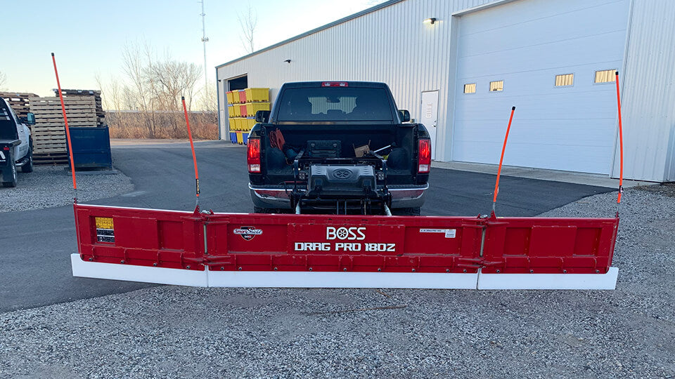 Load video: Image of May Wes Poly Cutting Edge installed on a Boss Drago Pro 180Z snow plow with wings extended.